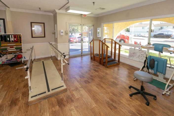A rehabilitation room equipped with ramps and stairs for physical therapy exercises.
