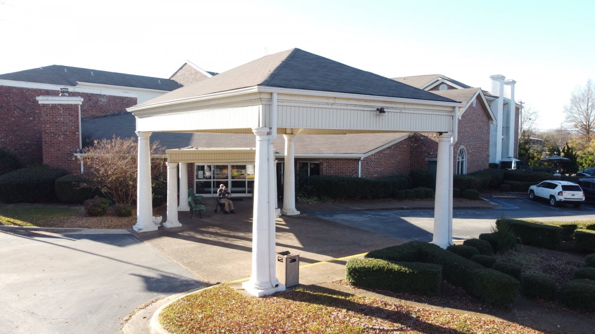 Entrance of a building with white columns and an awning.