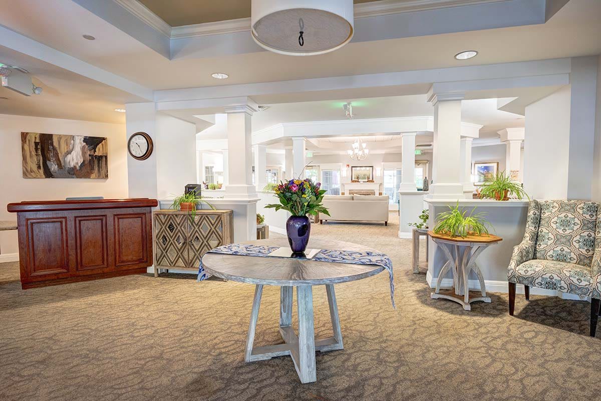 A welcoming lobby area with a central table adorned with flowers and elegant decor.