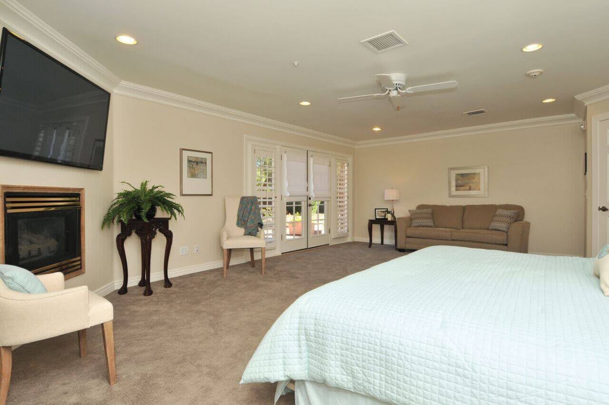 Spacious bedroom with elegant decor and natural light.