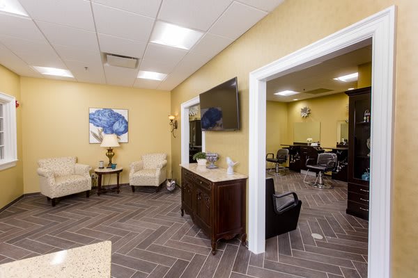 Modern salon interior with a waiting area and comfortable seating.
