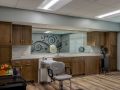 A modern hair salon interior with styling chairs, mirrors, and wooden cabinets.