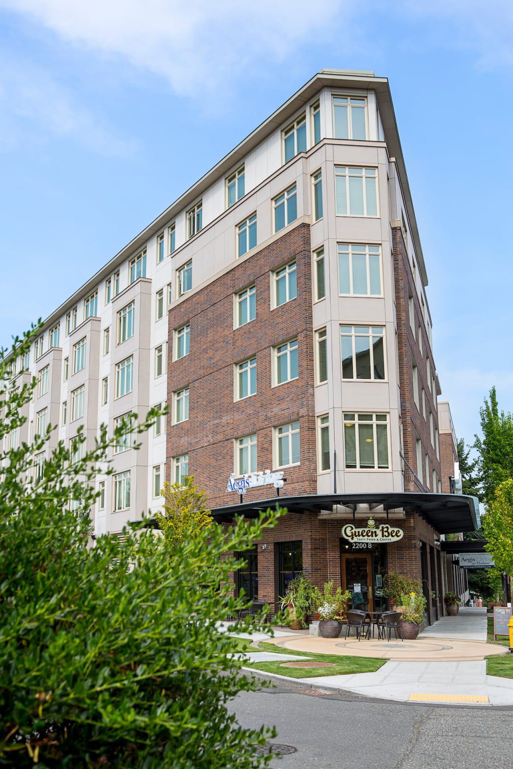 A modern hotel building with a blend of brick and glass facade in an urban setting.