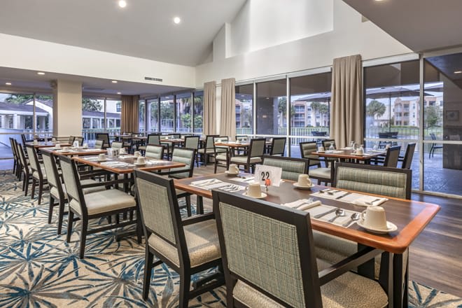 A modern restaurant dining area with neatly arranged tables and chairs, ready for guests.