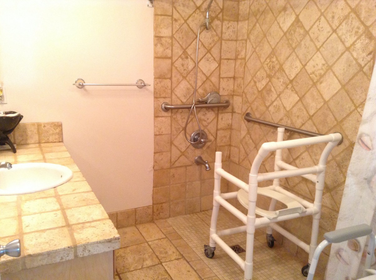 Accessible bathroom with grab bars and a shower walker.