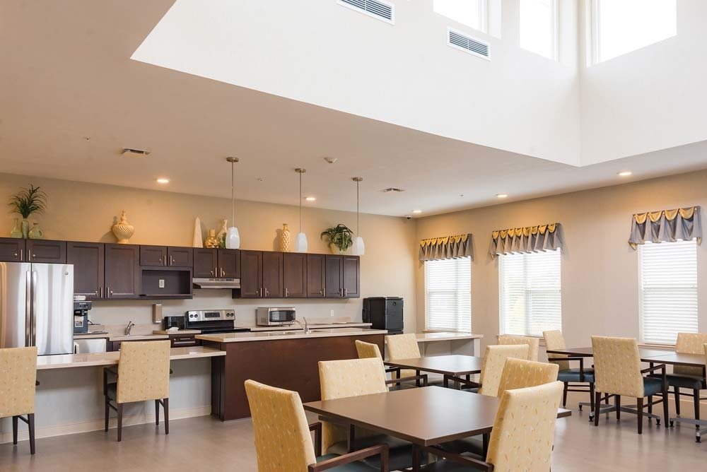 A modern kitchen and dining area with ample natural lighting and contemporary furniture.