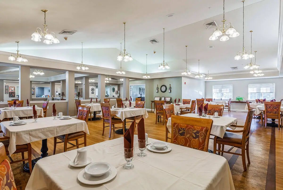 Elegant dining room with neatly set tables and ambient lighting.