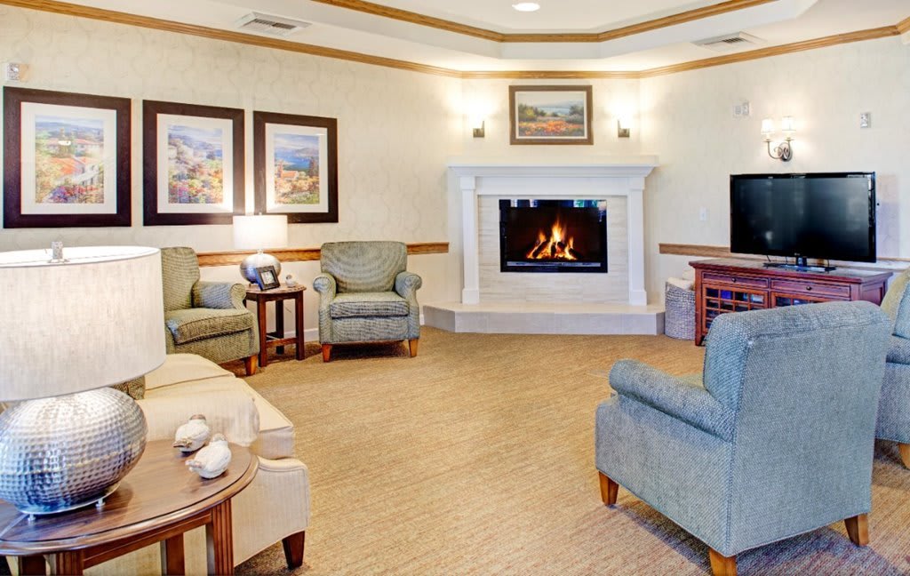 A cozy living room with a fireplace and comfortable seating.
