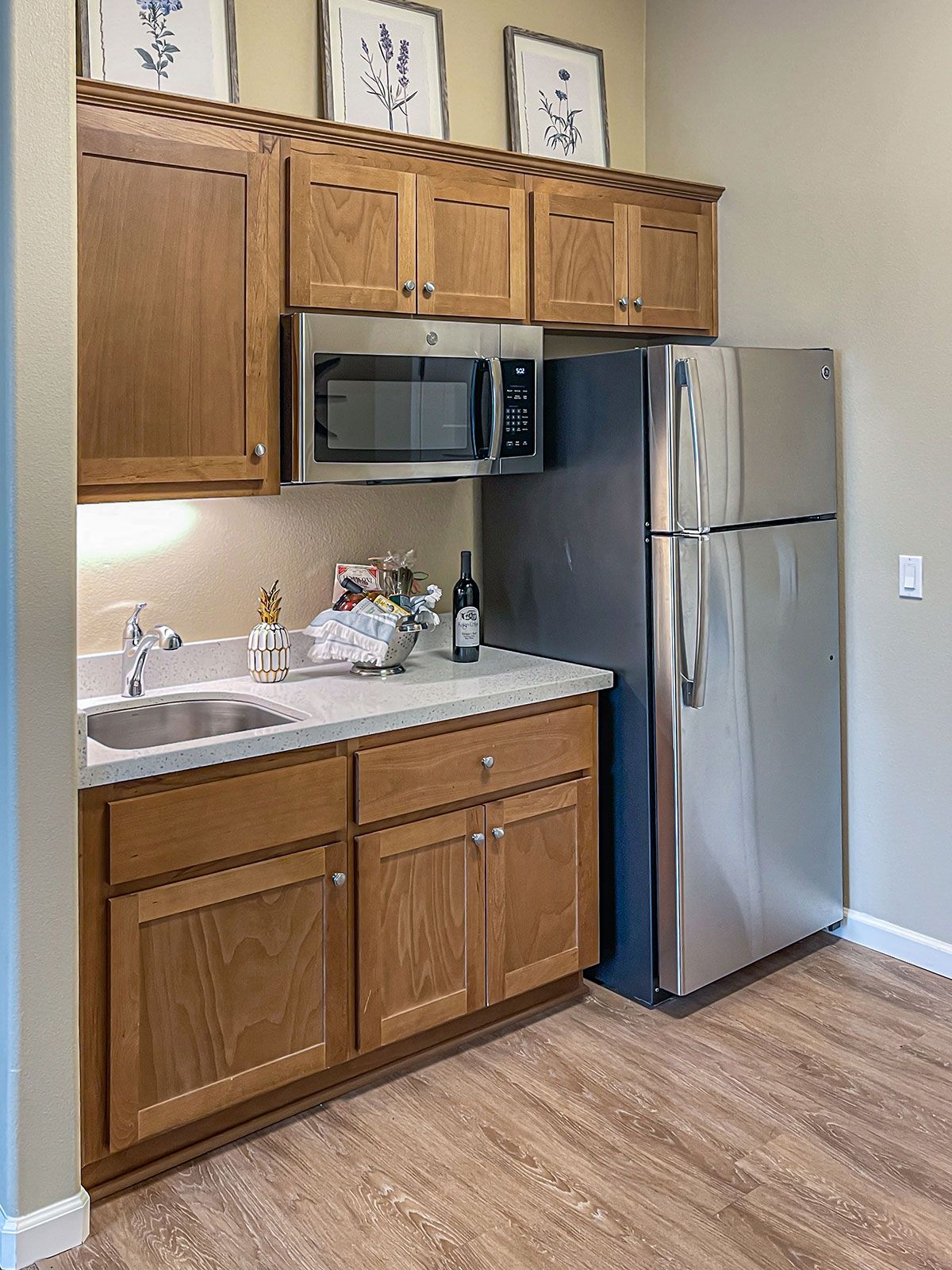 A compact kitchen with wooden cabinets, stainless steel appliances, and a clean countertop.