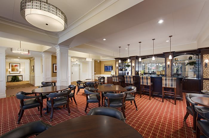 A stylish lounge area with a bar and seating arrangements.