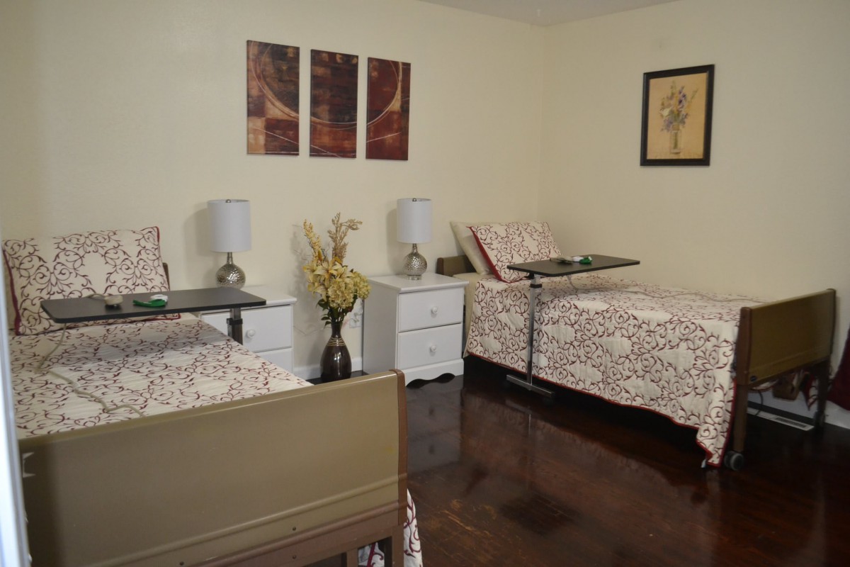 A cozy bedroom featuring two twin beds, bedside tables, and elegant decor.