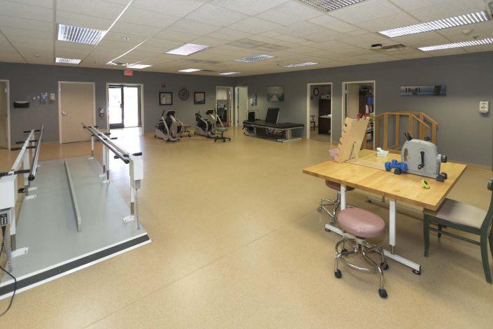 A spacious rehabilitation center equipped for physical therapy sessions.