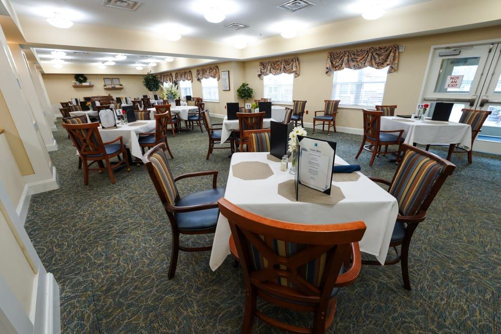 A spacious dining room with neatly arranged tables and chairs.