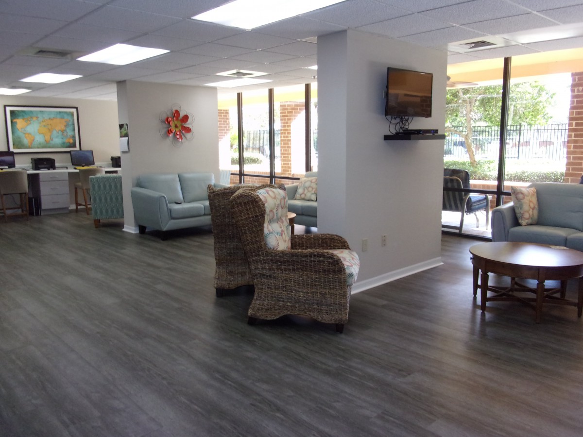 A modern, bright waiting room with comfortable seating and large windows.