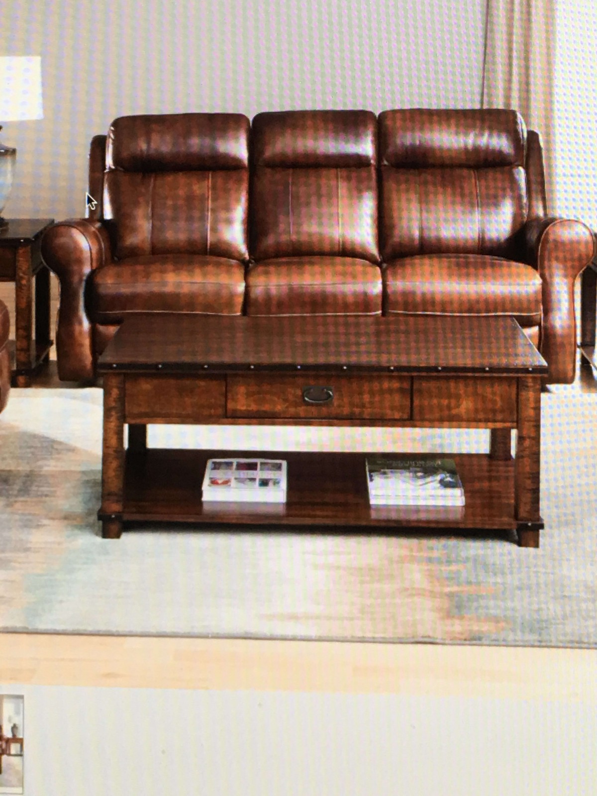 A cozy living room setup featuring a leather sofa and a wooden coffee table.