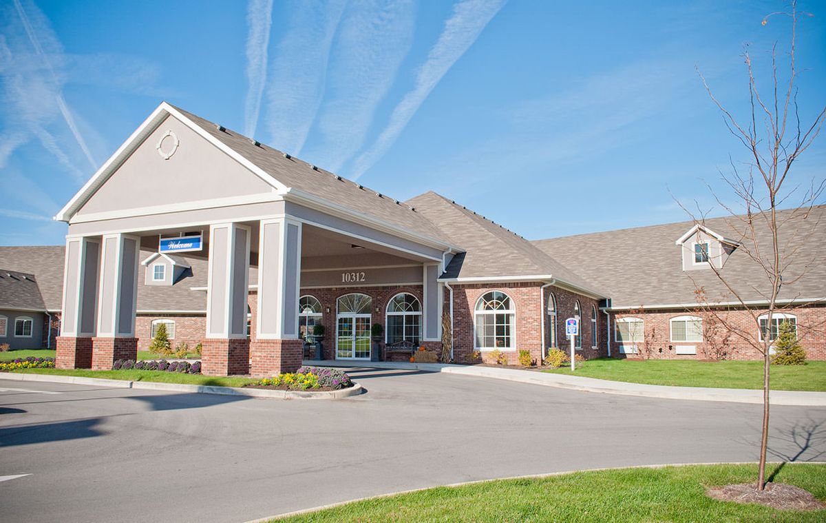 A modern building with a spacious entrance and clear blue skies overhead.