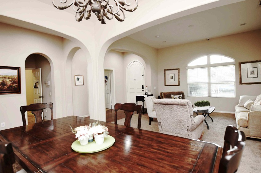 A spacious living and dining area with elegant furniture and decor.