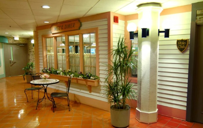 A cozy indoor space with a small table, chairs, and decorative plants.