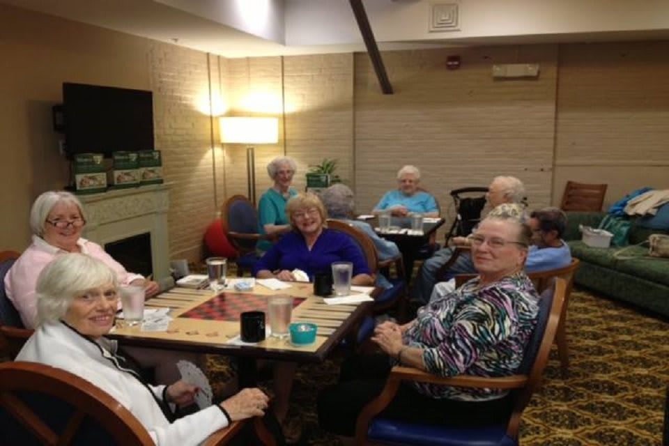 A group of seniors enjoying a social gathering indoors.