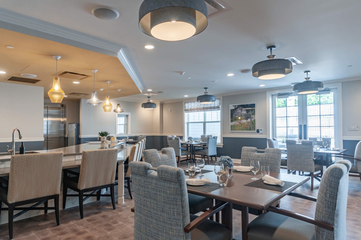 A modern dining room with stylish furniture and elegant lighting fixtures.
