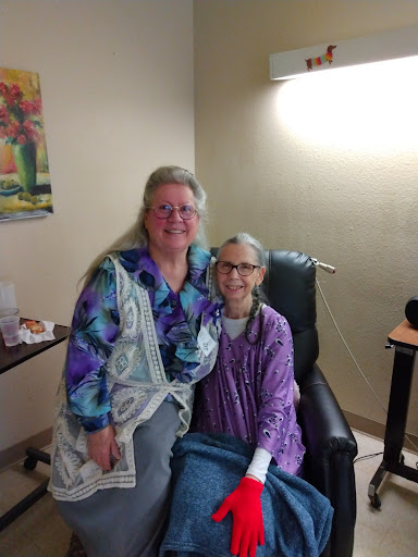 A heartfelt moment between a caregiver and her friend in a hospital setting.