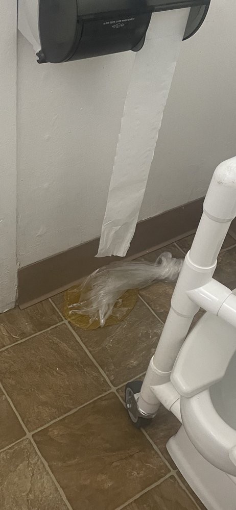Water leakage by a bathroom wall near the toilet.