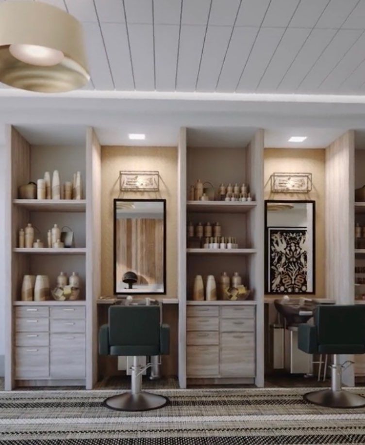 A modern salon interior with chairs and shelves filled with hair care products.