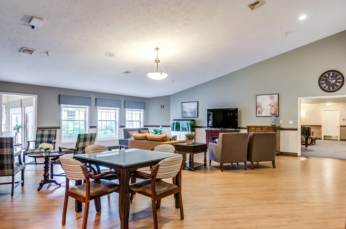 A modern open-concept living and dining area with stylish furniture and large windows.
