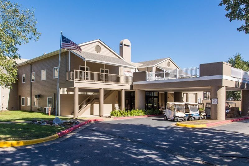 The exterior of a hotel building with an entrance area and a flag displayed outside.
