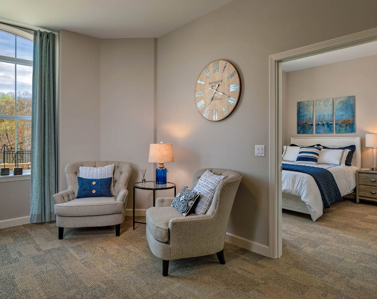 Cozy seating area adjacent to a bedroom with modern decor.