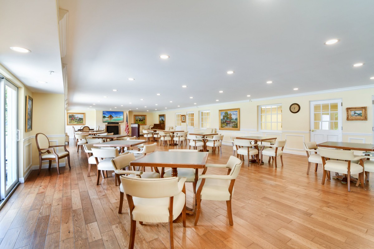 A spacious dining area with several tables and chairs, well-lit and inviting.