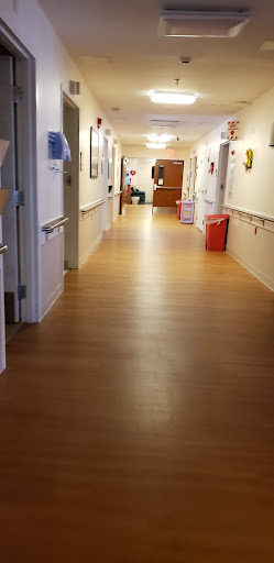 A well-lit and clean hallway in a hospital.