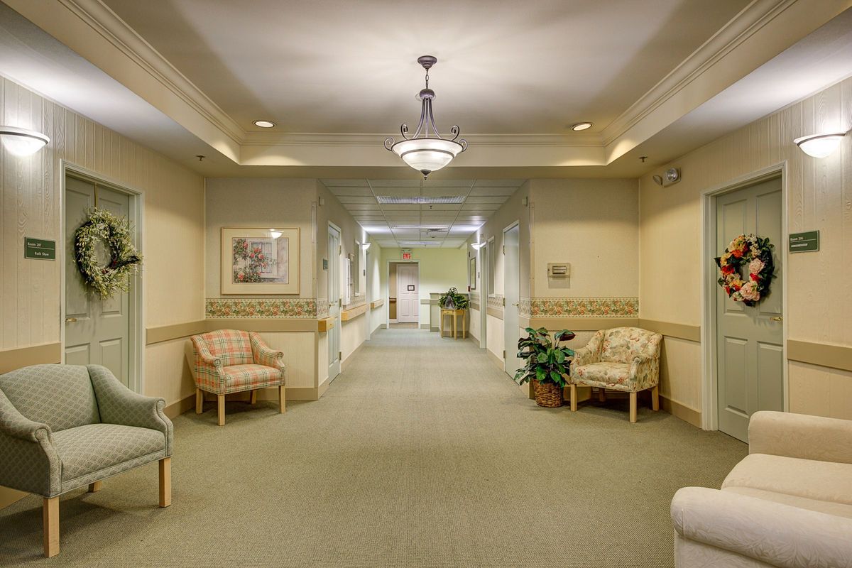 A well-lit hallway with seating and decorative elements.