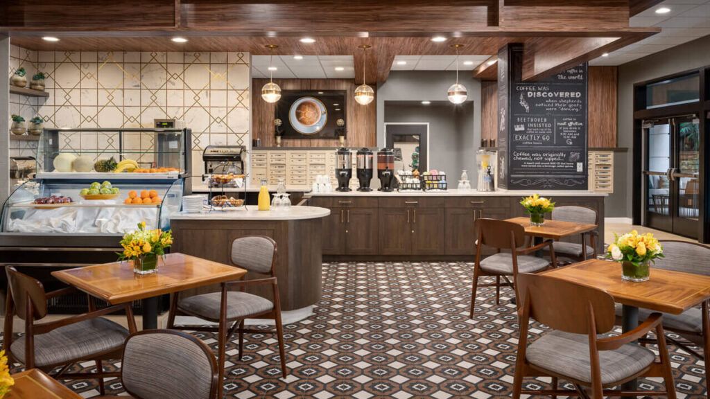 A modern cafe interior with stylish tiles, comfortable seating, and a well-organized counter.