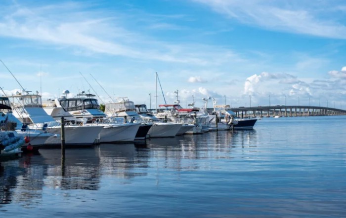 A serene marina with boats docked under a clear blue sky.