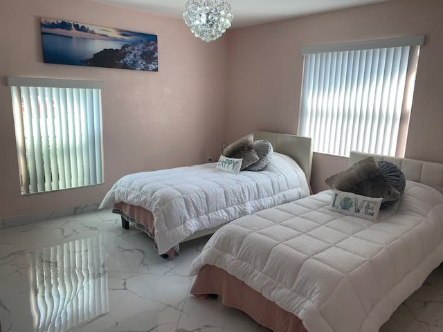 A modern bedroom with two cozy twin beds and elegant decor.