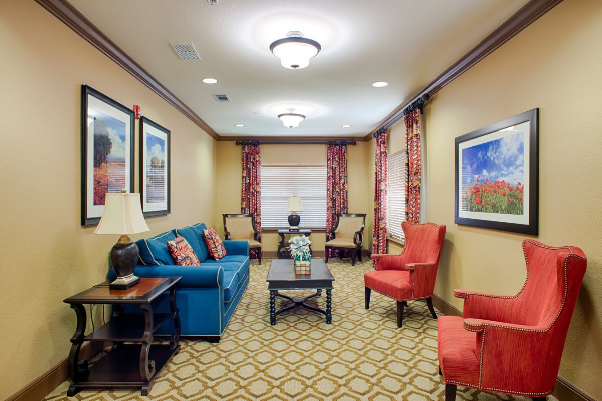 A cozy living room featuring colorful furniture and decorative artwork.