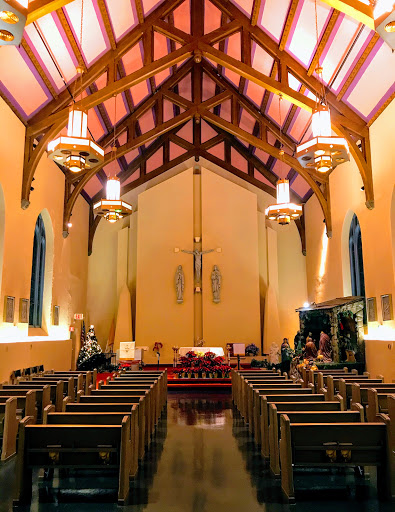 A serene view of the interior of a church featuring wooden beams and elegant lighting.