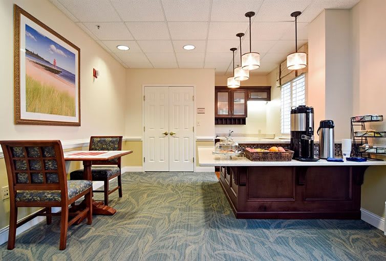 A cozy kitchen area with a coffee station and seating.