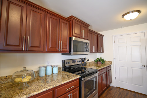 A modern kitchen featuring rich wooden cabinets and sleek stainless steel appliances.