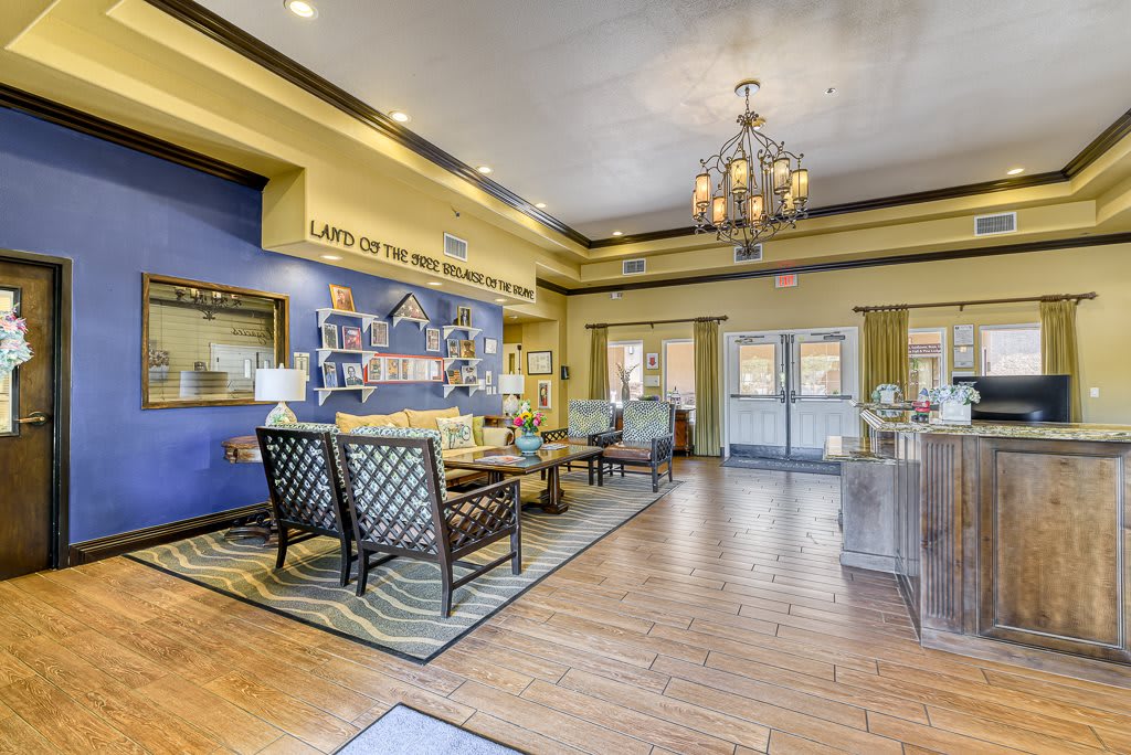 A cozy and well-decorated lobby with comfortable seating and a chandelier.