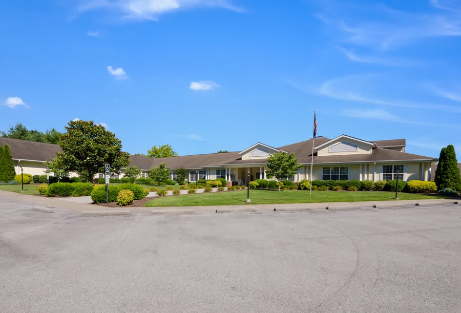 A single-story building surrounded by landscaping under a clear blue sky.