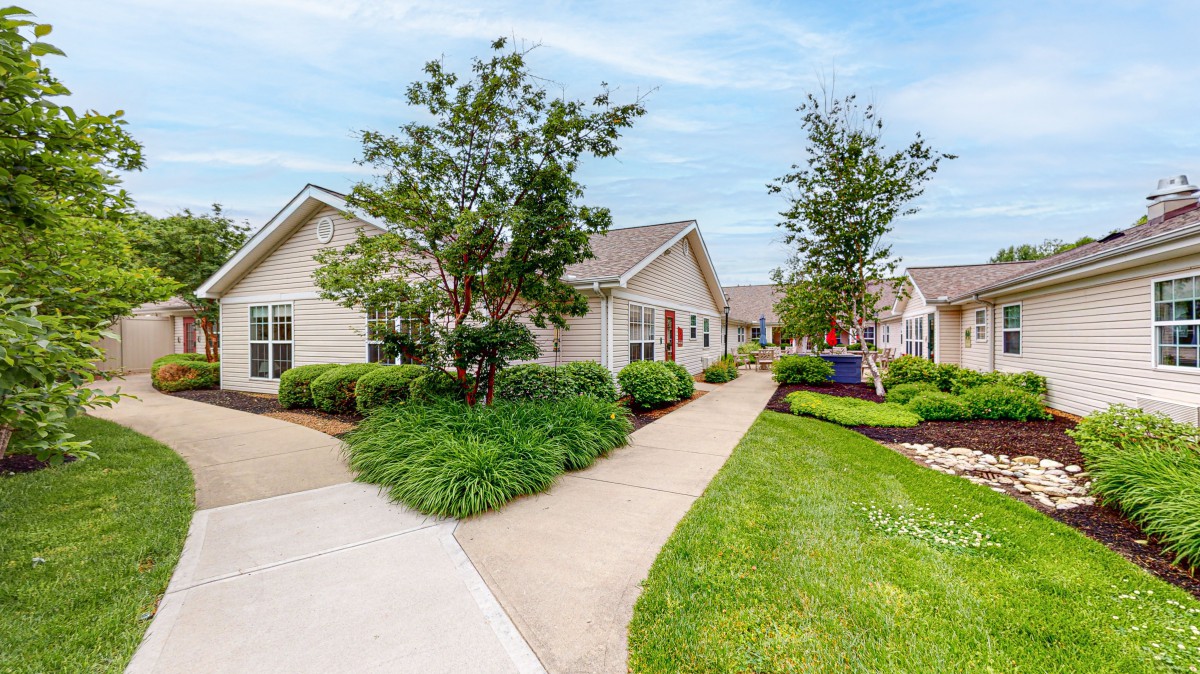 A well-maintained suburban neighborhood with lush greenery and clean pathways.