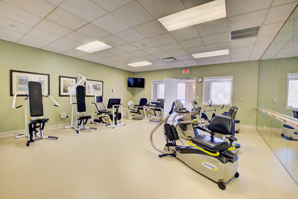 A well-equipped gym with various exercise machines and fitness equipment.