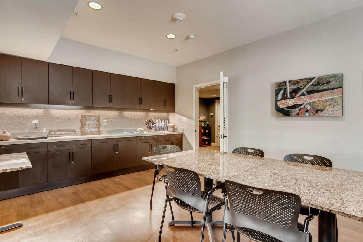A modern kitchen and dining area with sleek cabinets and a spacious table.