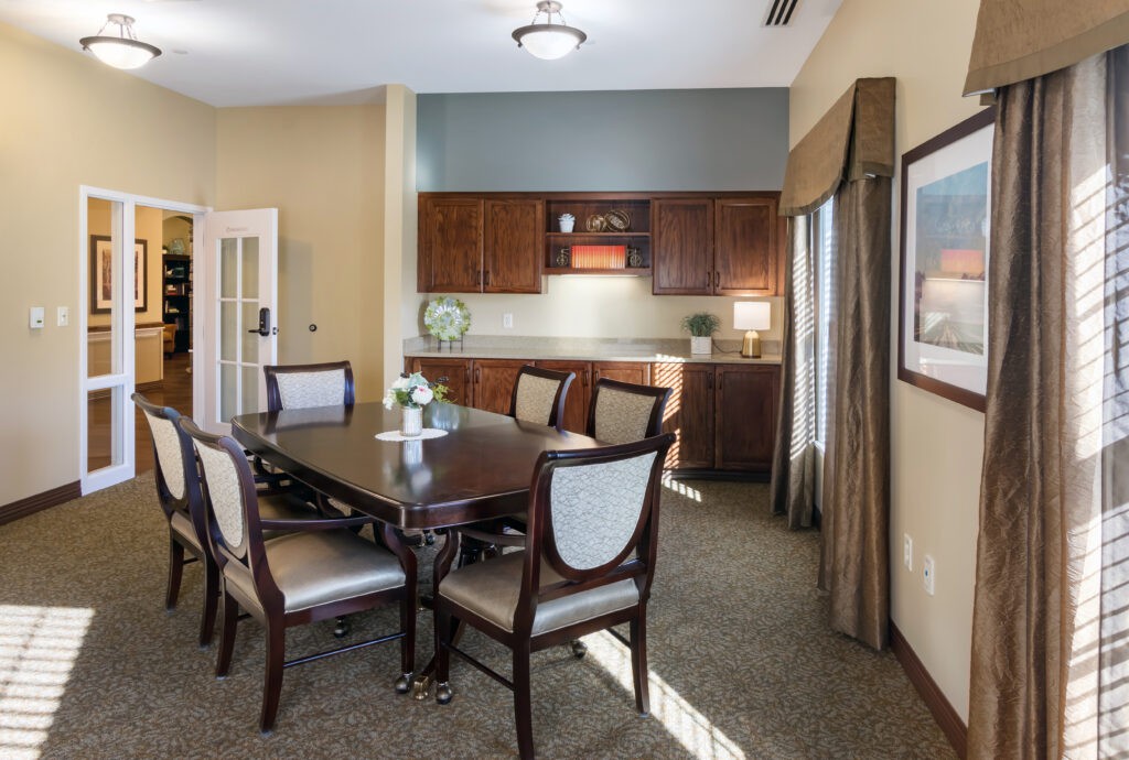 A well-appointed dining area with a wooden table, chairs, and cabinetry.