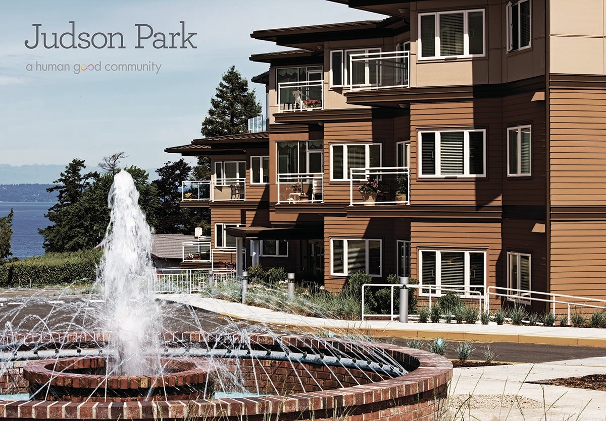 A modern apartment complex with a central fountain feature.