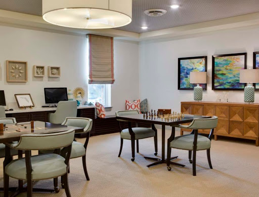 A modern and stylish office space featuring a comfortable seating area and elegant decor.