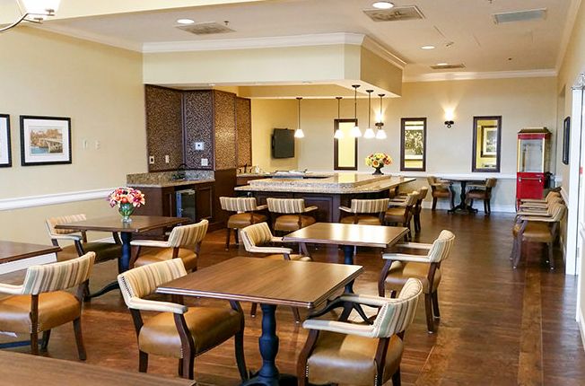 A cozy indoor dining area with wooden tables and comfortable seating.