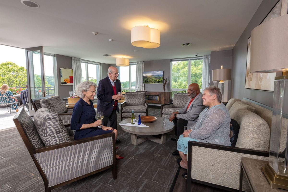 A group of people engaged in a discussion in a modern office setting.